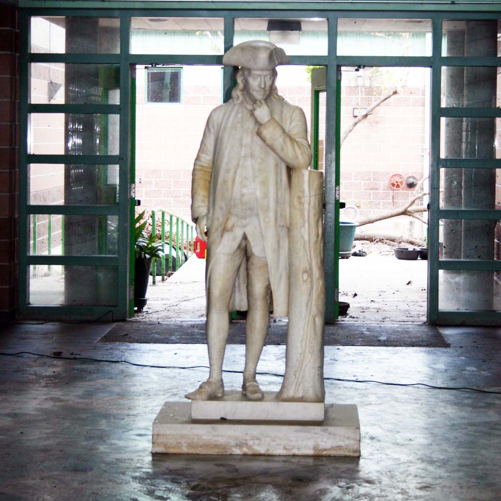 Close-up of a dirty statue of Ben Franklin after Hurricane Katrina.