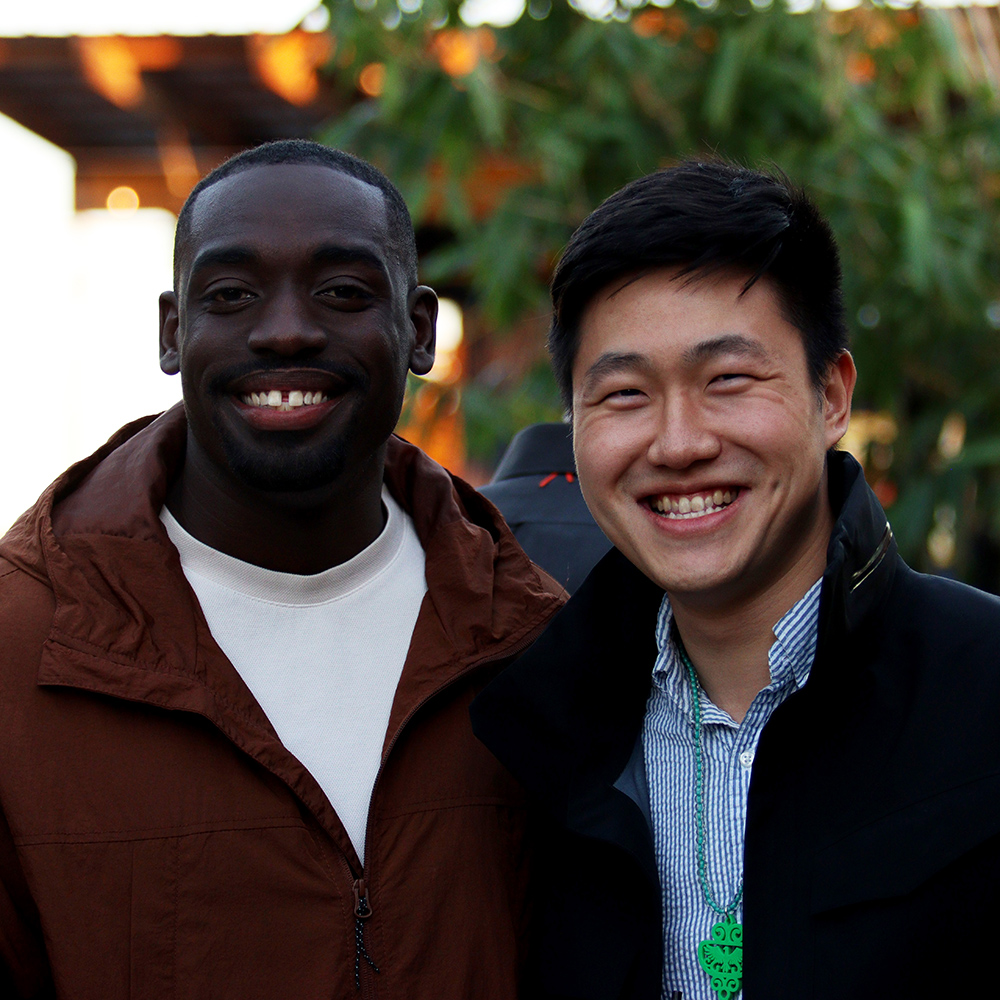 two multi-racial men smiling and enjoying bennaroo
