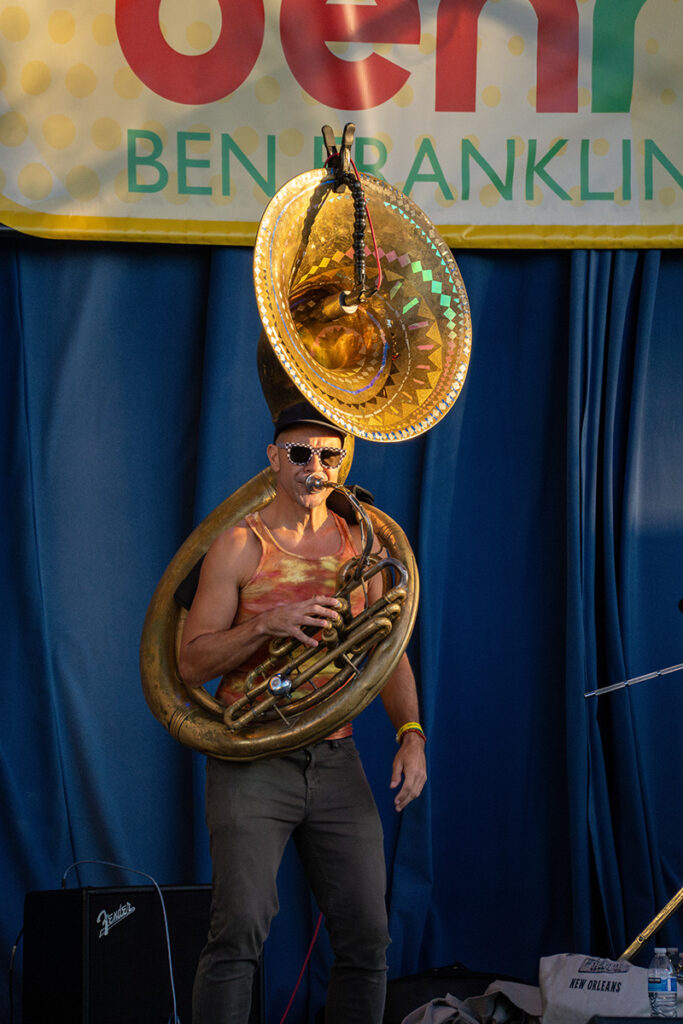 Male musician on stage playing the tuba at Bennaroo