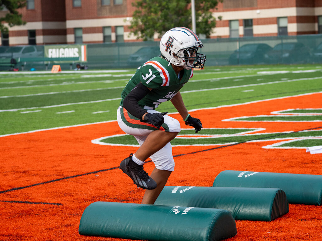 Football player on Rose Field running drills