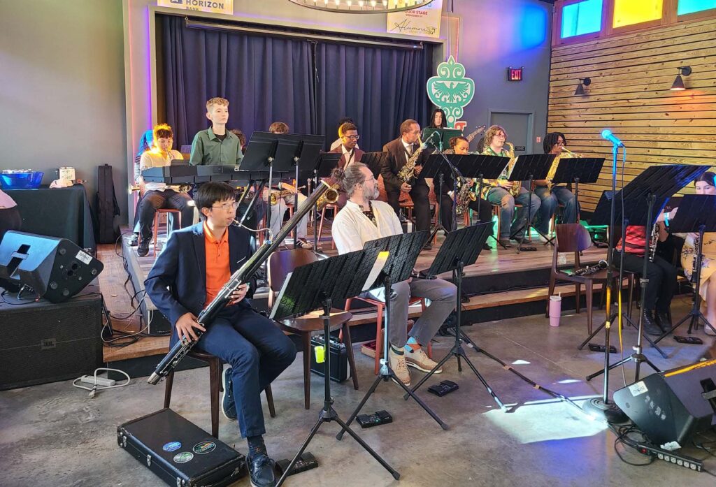 Students performing with instruments on stage during Bennaroo