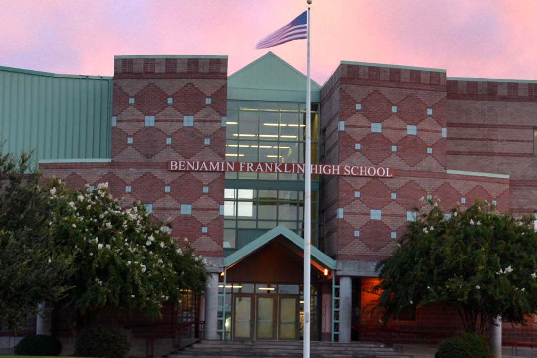 Front of Ben Franklin High School with an American Flag