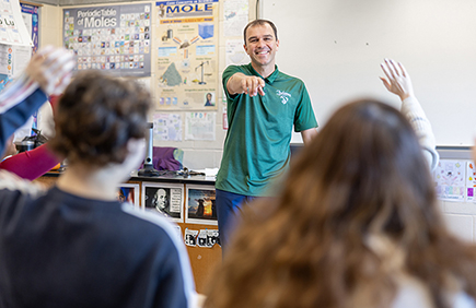 Teacher points to student to answer a question in class
